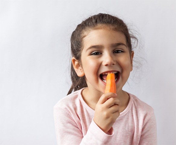 Litte girl eating a carrot
