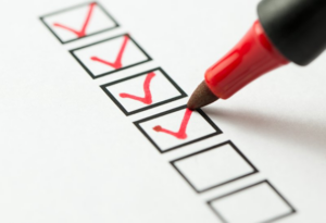 Red marker checking off a checklist